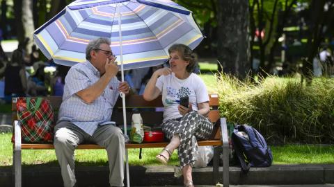 Dos personas se protegen del sol en el centro de Oviedo - Eloy Alonso.jpg